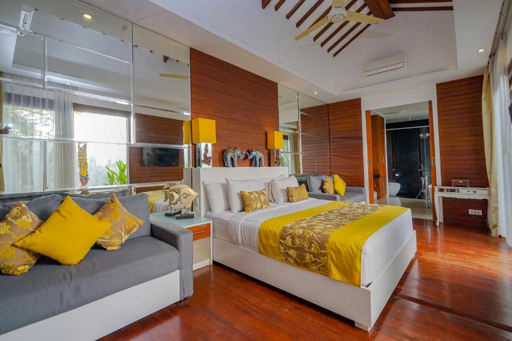 Bedroom with sofa at  Anari Villas Kuta