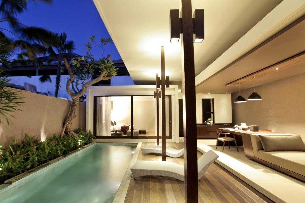 Swimming pool with lounge chair at Asa Luxury Villas in Seminyak