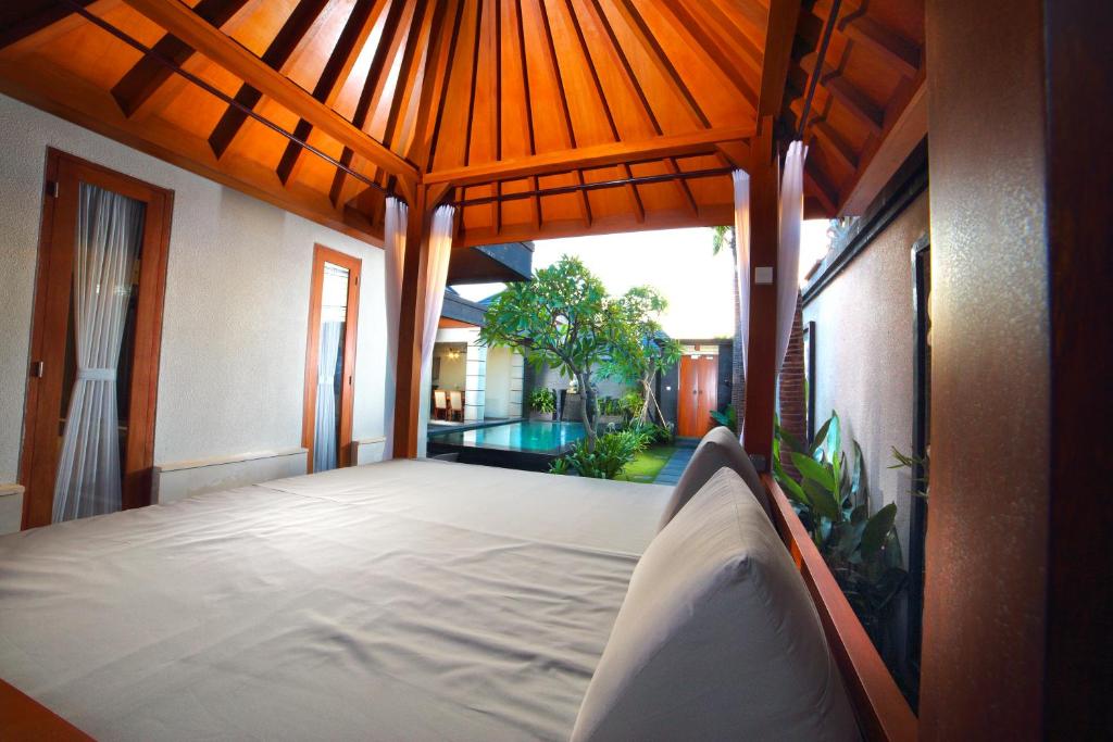 Bedroom with swimming pool at The Banyumas Suite Villa Legian