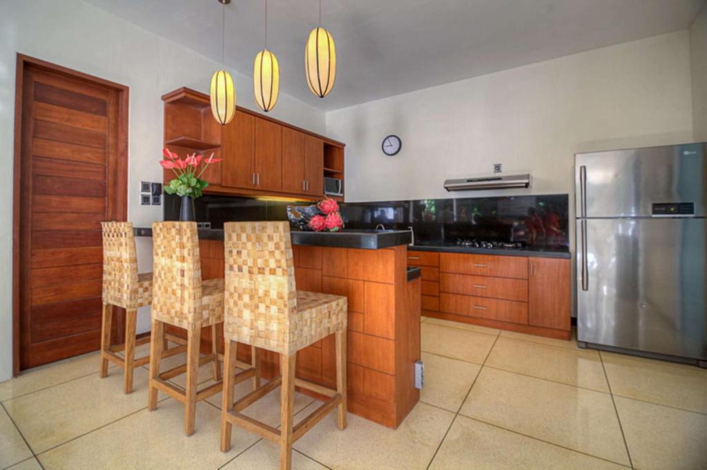 Kitchen with fridge at Rent a Luxury Villa