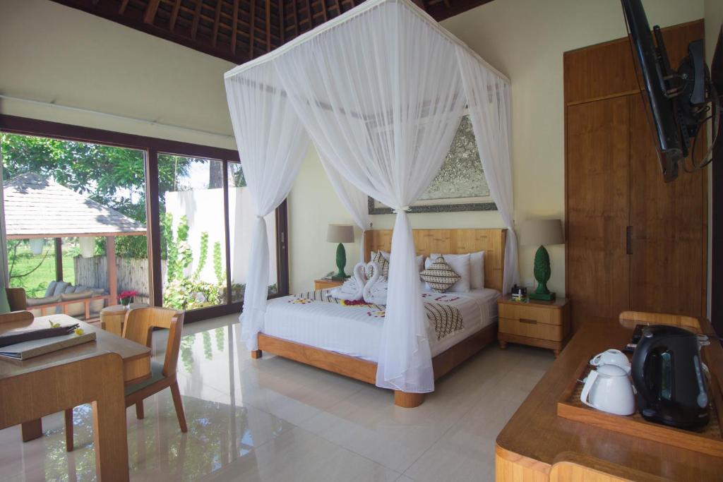 Bedroom with dinning table at Santun Luxury Private Villas