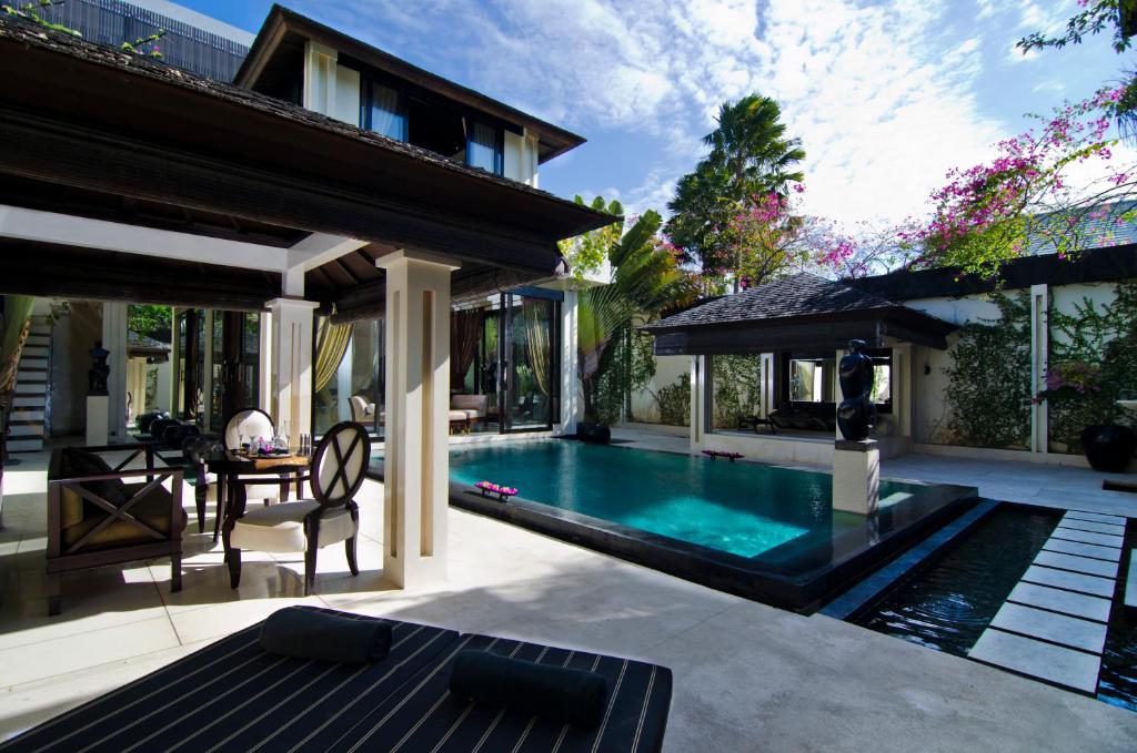 Swimming pool with table at Villa One Seminyak