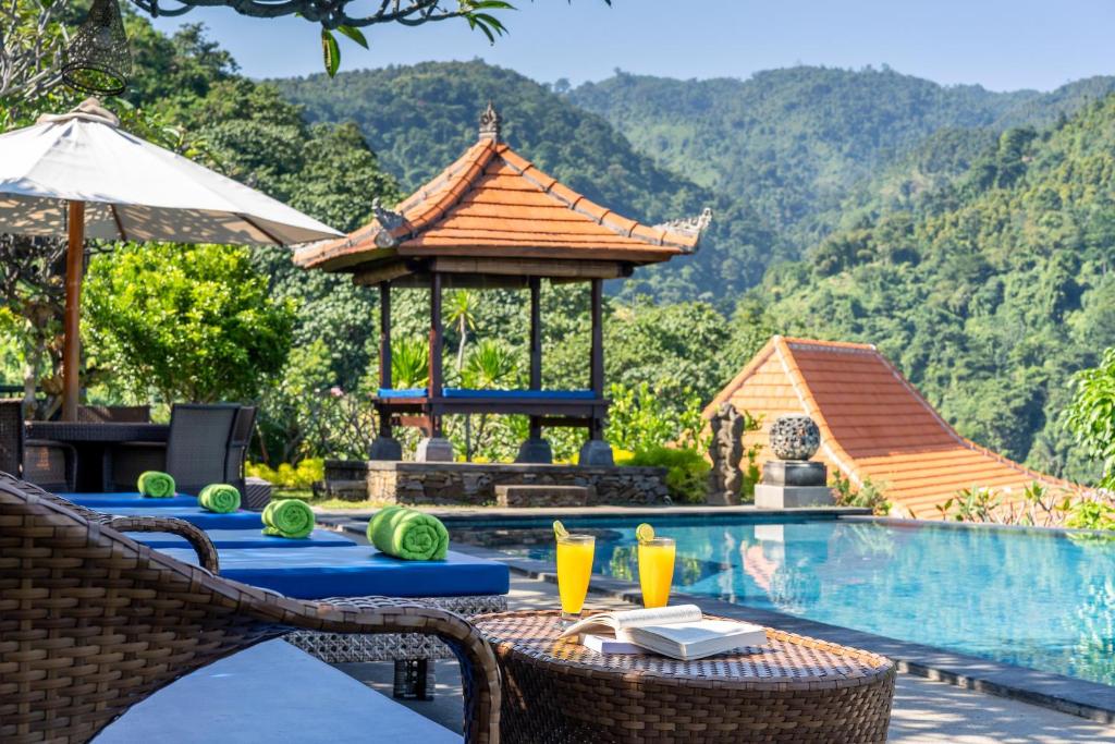 Infinity pool with mountain and gazebo view