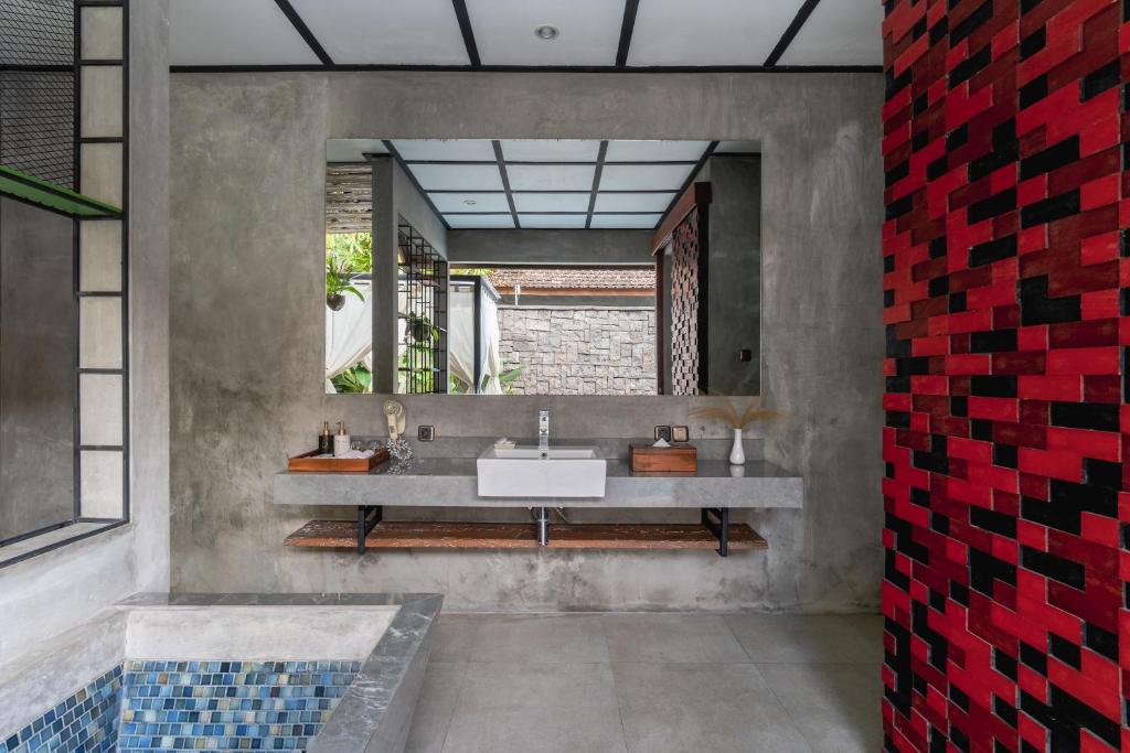 Modern bathroom with concrete walls and red tiles