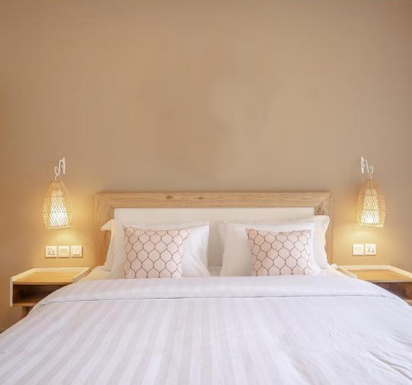 Minimalist bedroom with soft lighting and decorative pillows