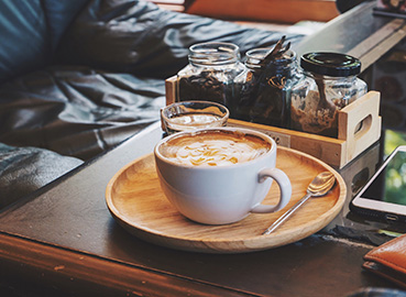 A cozy coffee setup on a wooden tray
