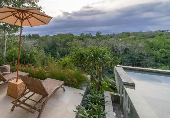 Cliffside villa with lounge chairs and pool