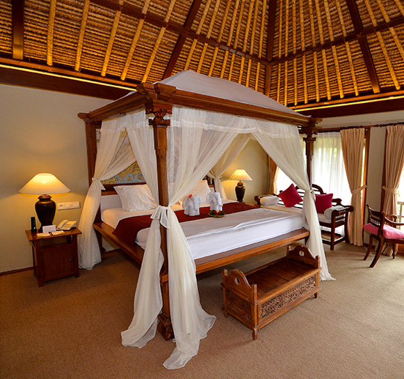 Elegant bedroom with a four-poster bed and tropical decor