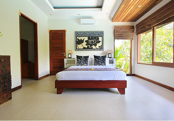 Contemporary bedroom with wooden decor in Seminyak villa
