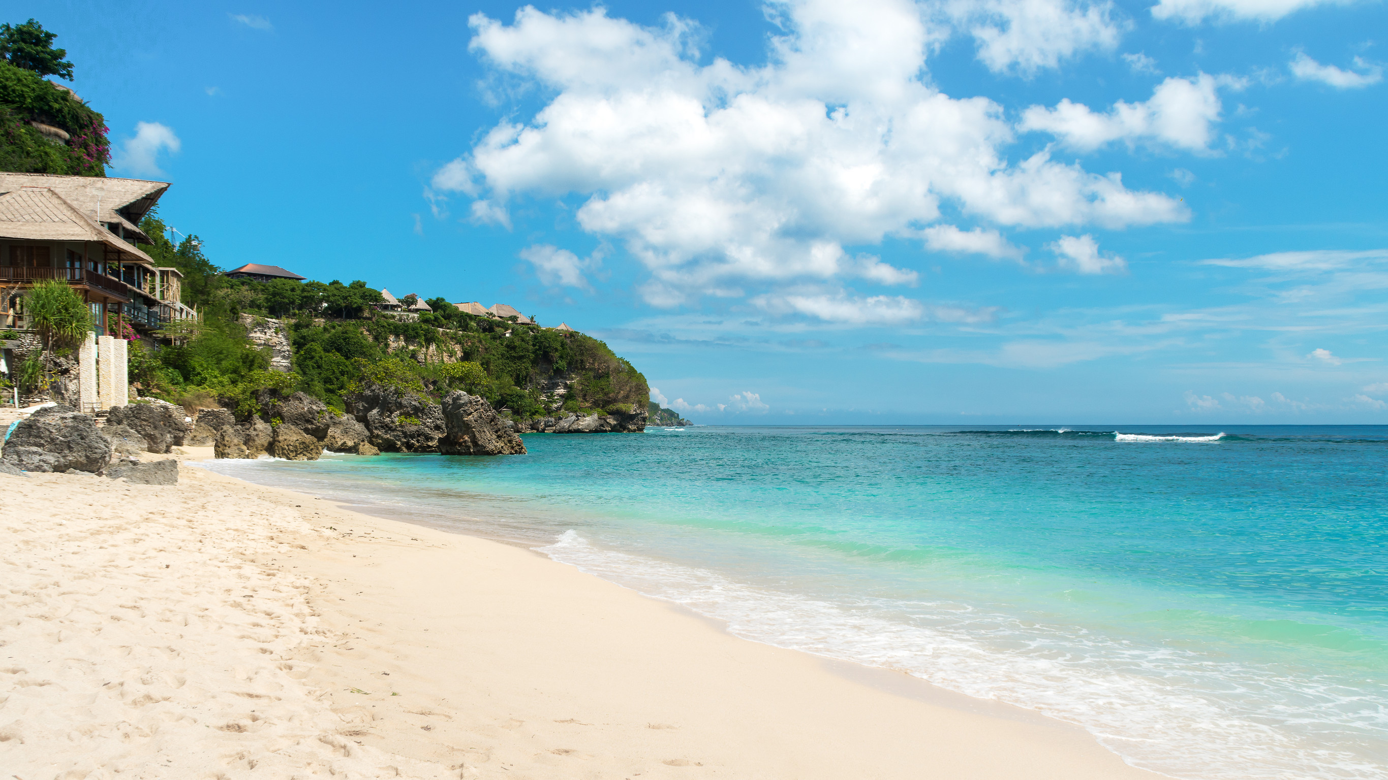 White sand beach with cliffs and houses
