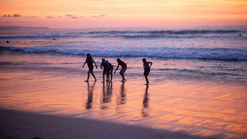 Families enjoying and playing in the waves at the beach