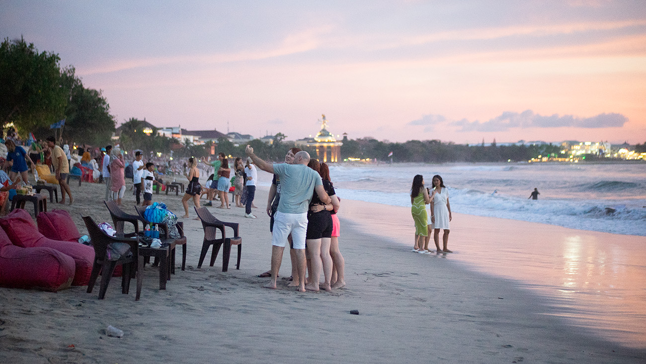 Family taking a selfie on the beachfront at Kuta Beach