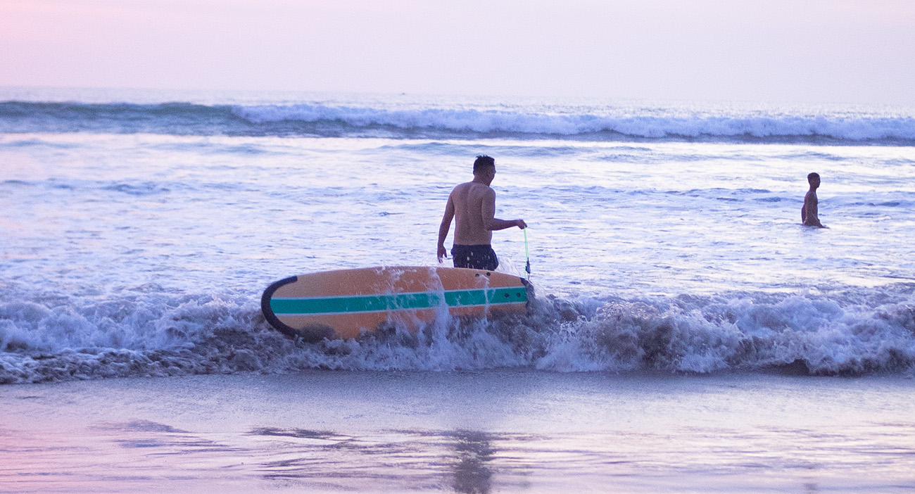 Man surfing in the sea at Kuta Beach