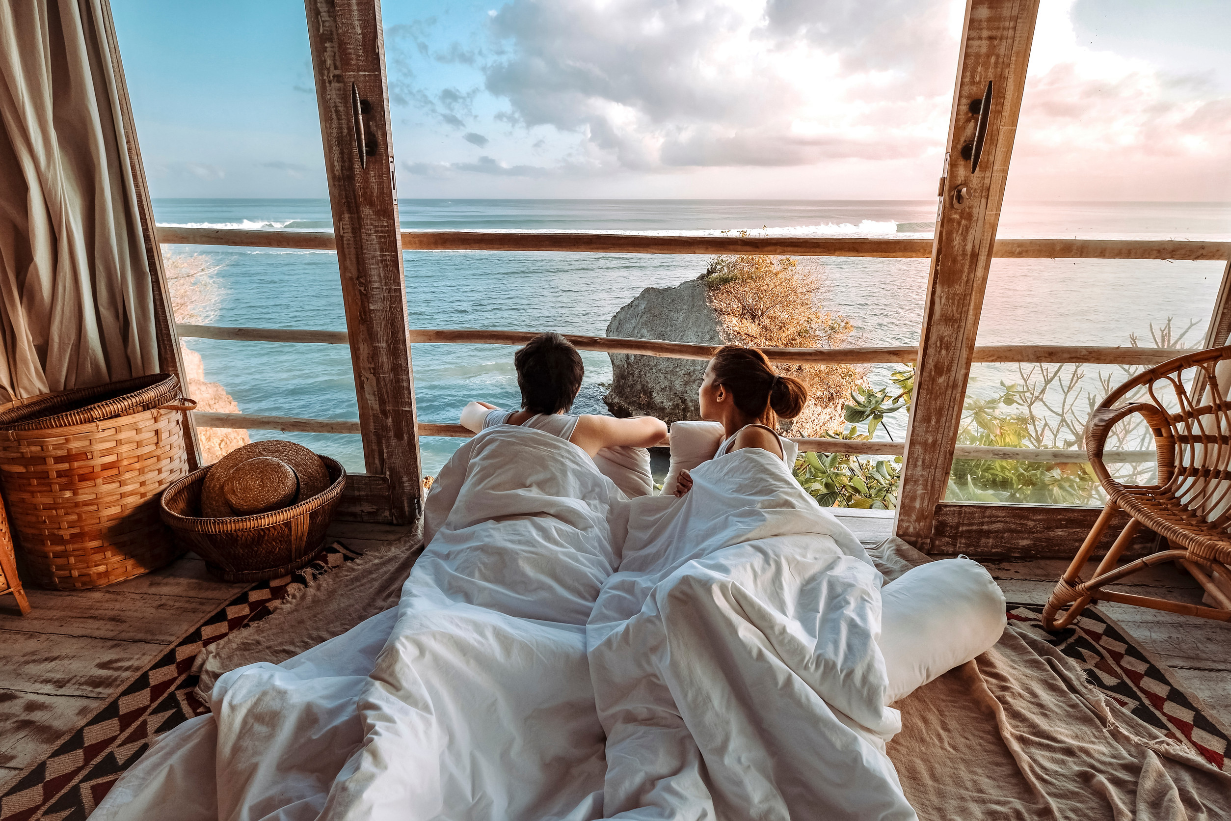 Couple looking at the sea from a bedroom