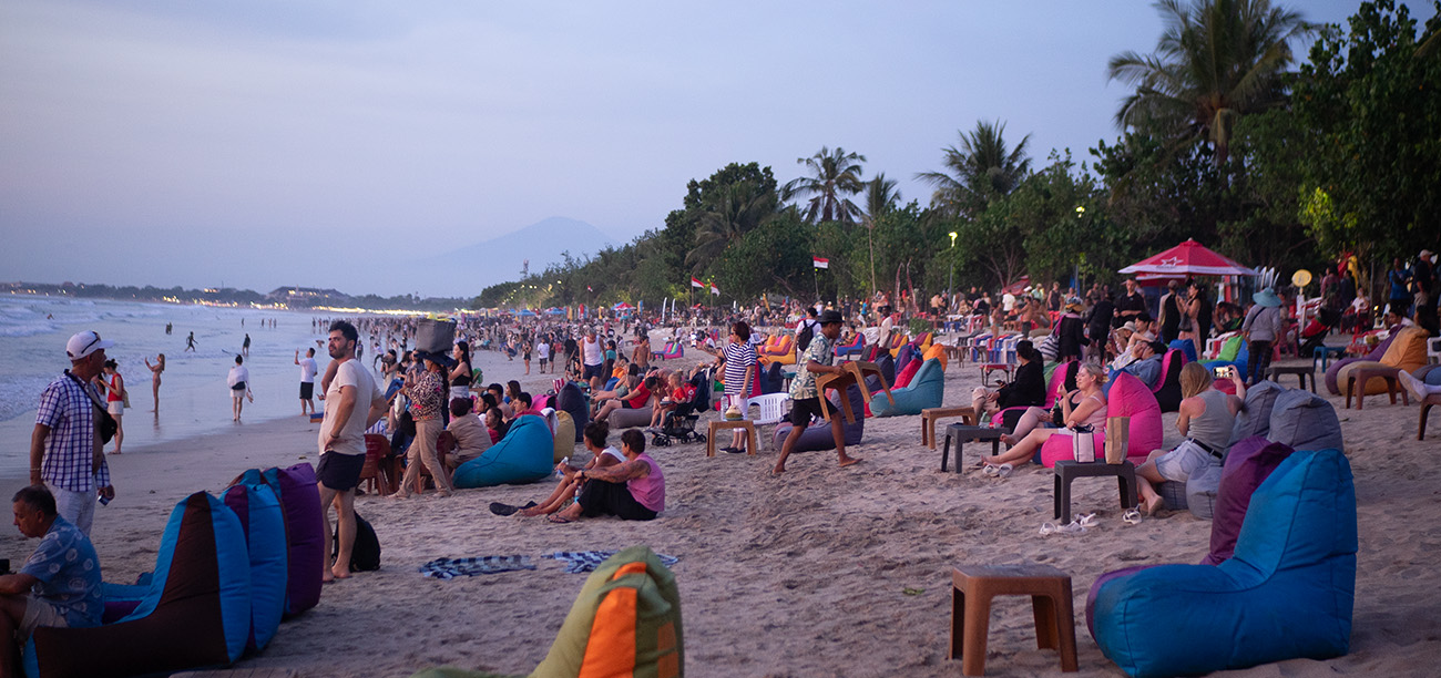 Many people relaxing on chairs at the beachfront