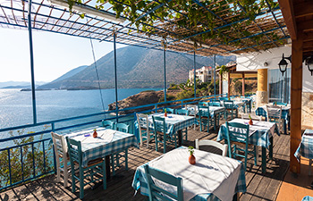 Seaside restaurant with tables overlooking bay