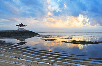 Sunrise over calm Sanur beach