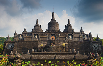 Stone temple complex with central Buddha statue