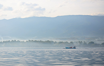 Lovina coastline with mountain backdrop and misty skies