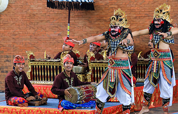 Traditional Balinese dancers in costume performing outdoors
