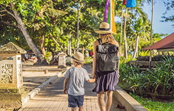 Mother with child in tropical park
