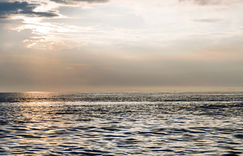 Sunset view over ocean with peaceful atmosphere