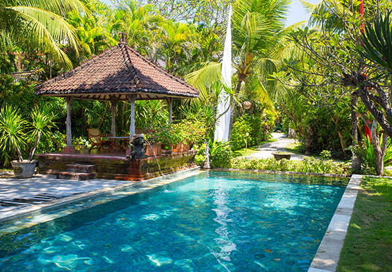 Poolside gazebo surrounded by tropical greenery
