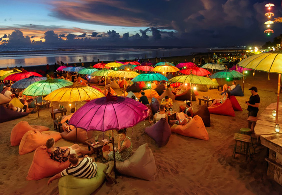 Colorful beachside restaurant with umbrellas and seating