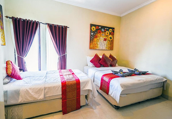 Spacious bedroom with two beds and decorative pillows
