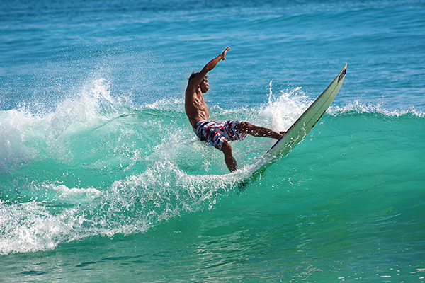 Surfer performing a trick on a wave
