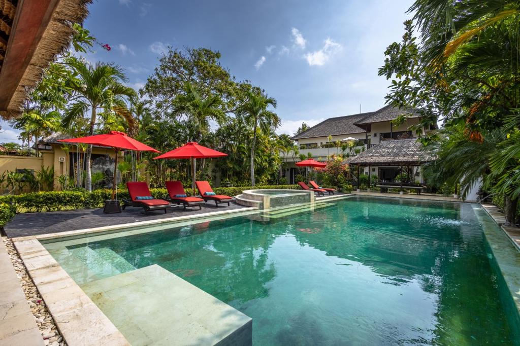 Outdoor pool with red loungers