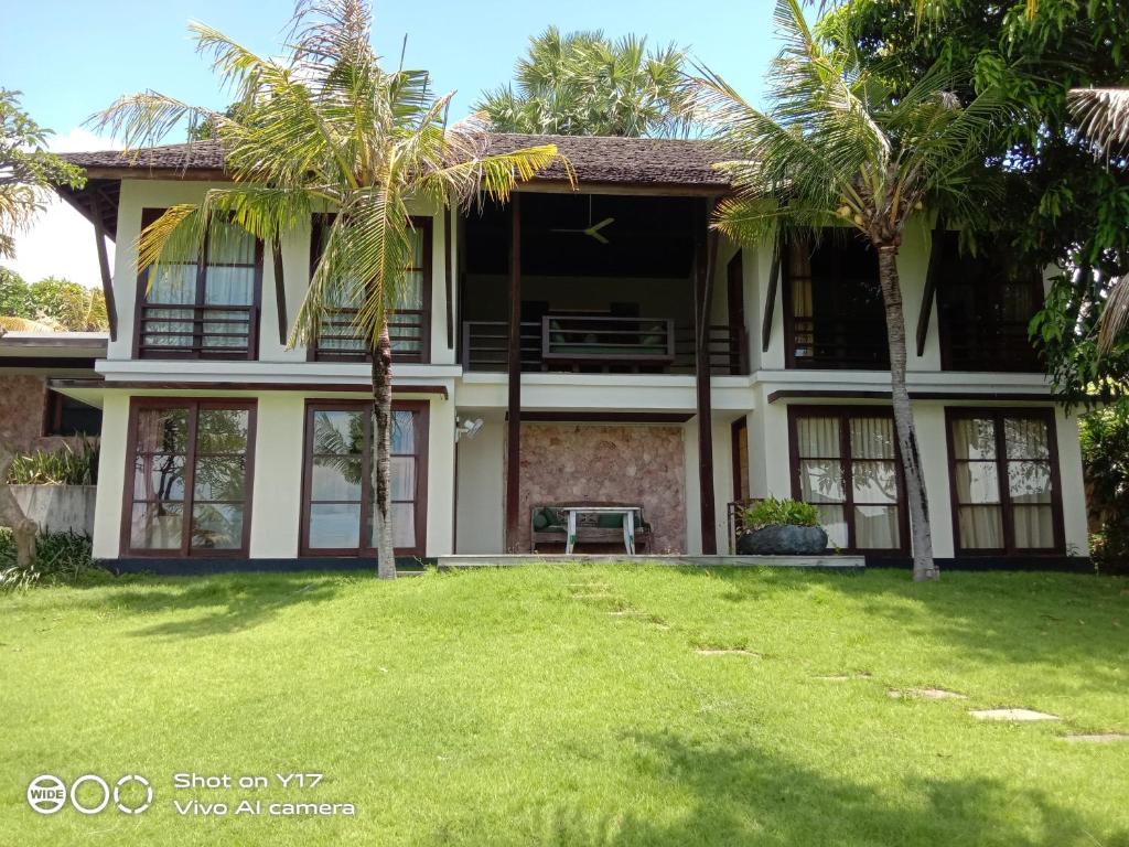 Two-story villa with palm trees