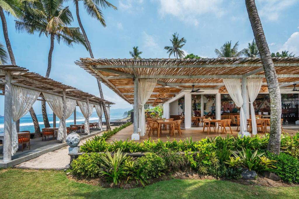 Beachfront restaurant with bamboo seating and ocean views