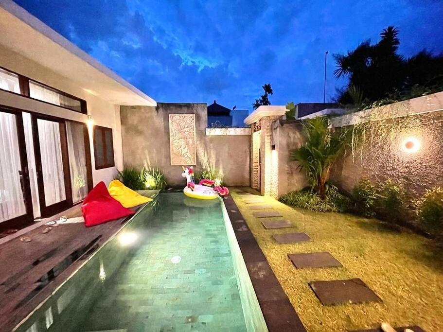 Night-lit pool with cozy seating