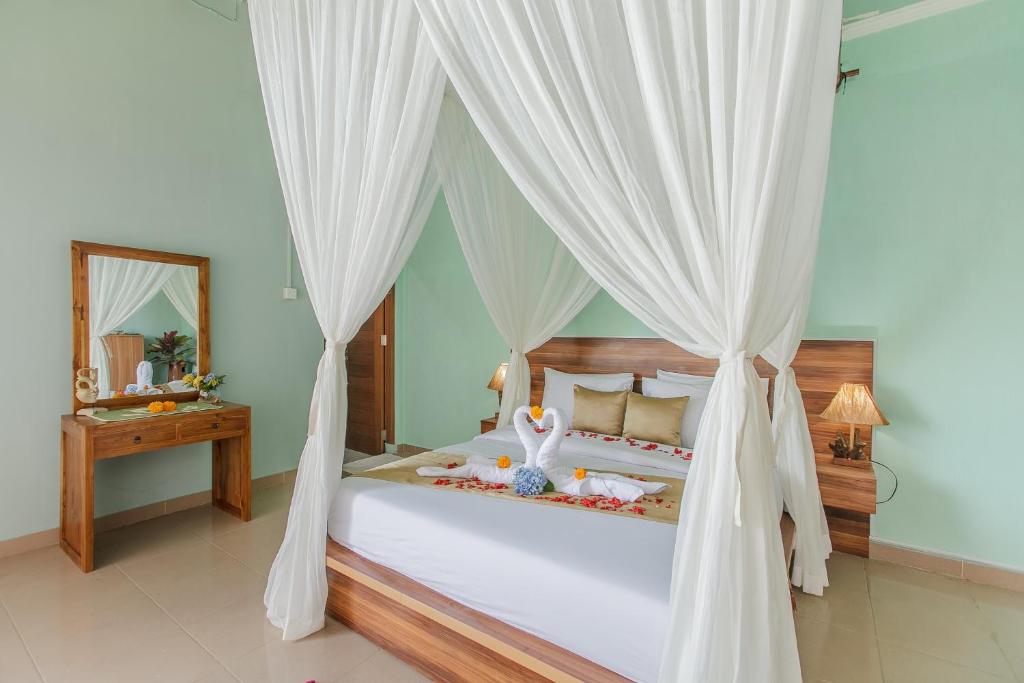 Elegant canopy bed in green-themed room