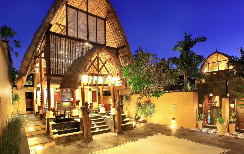 Tropical villa at night with bamboo roofing