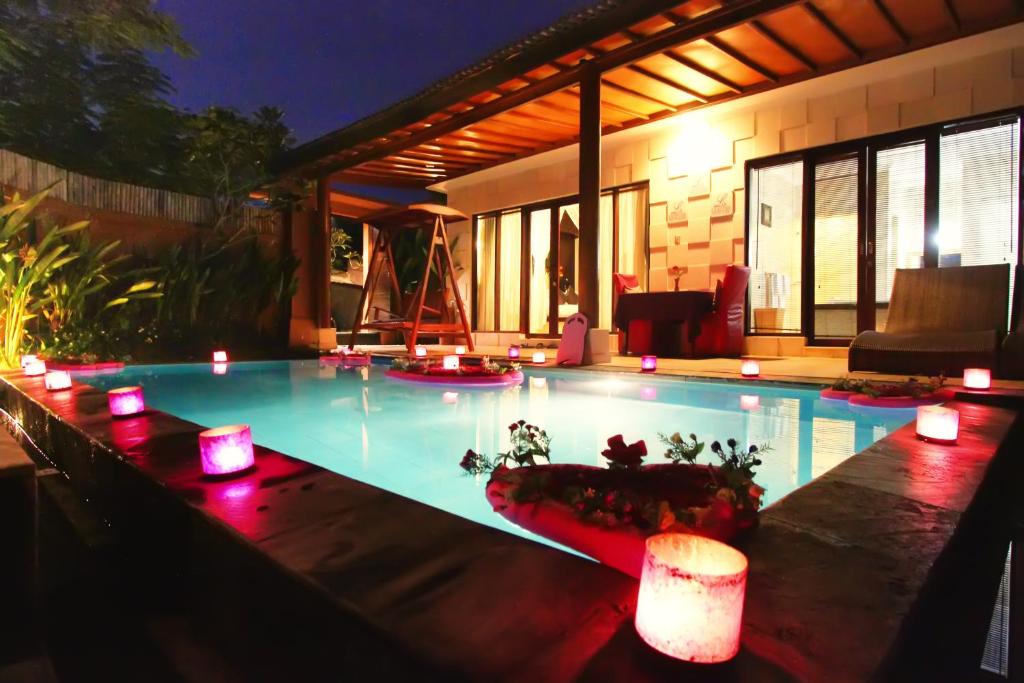 Candlelit poolside villa at night