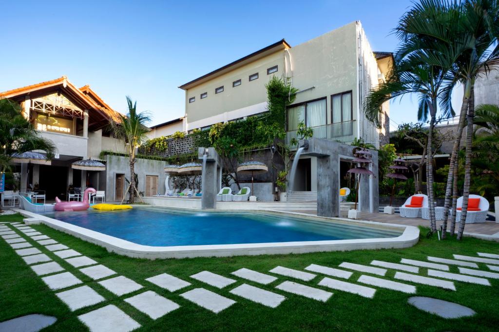 Villa with pool and colorful seating.