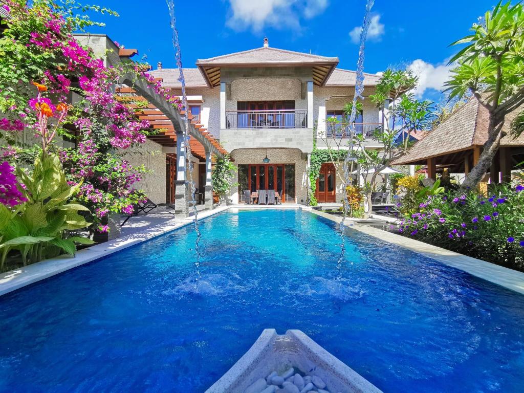 Villa pool with fountain and tropical plants