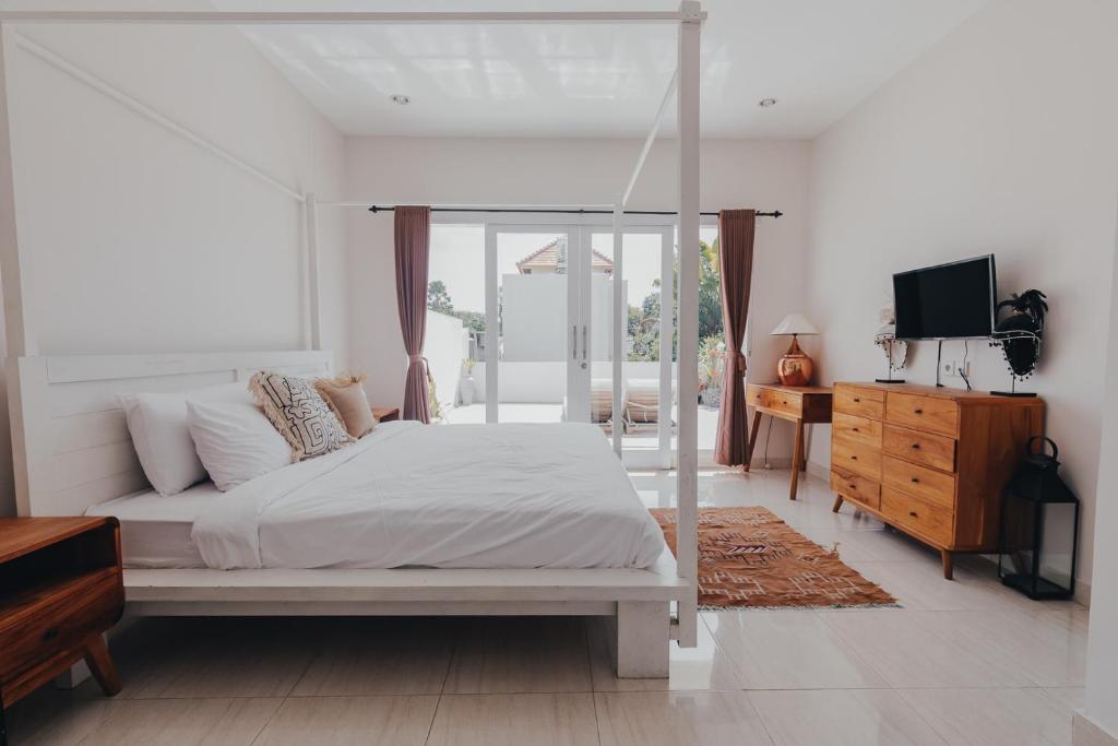 Bright bedroom with minimalist decor and a balcony view