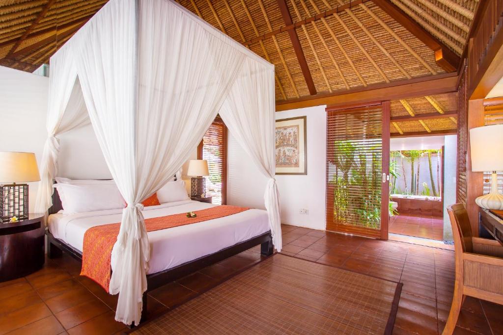 Tropical villa bedroom with a canopy bed and natural decor