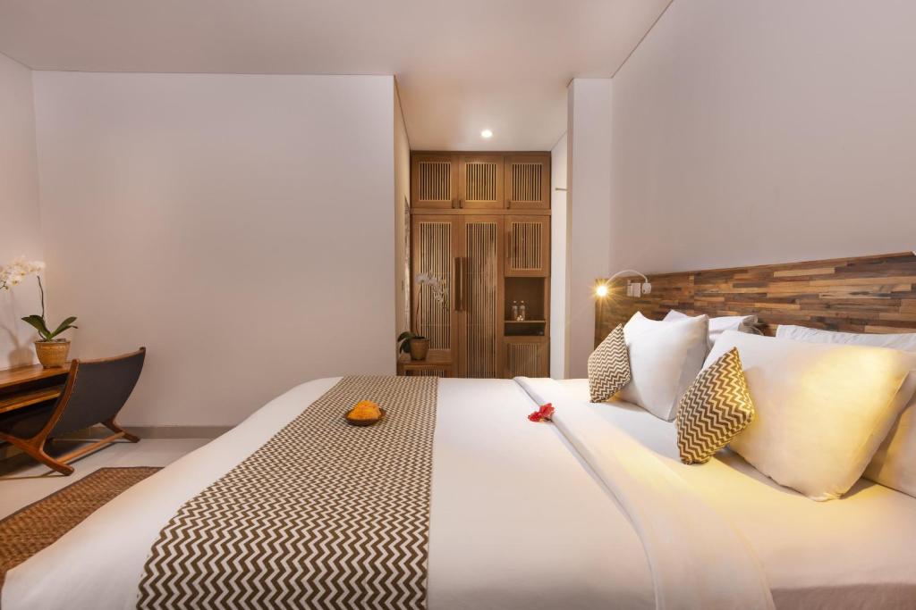 Bedroom with wooden decor and white bedding