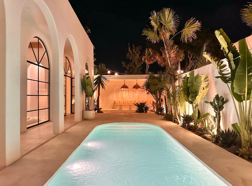 Modern villa with illuminated pool at night